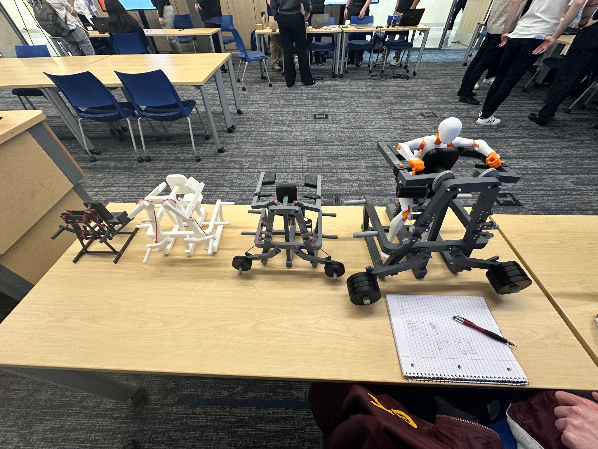 Four prototype generations of the latissimus dorsi adduction machine presented at the senior design showcase