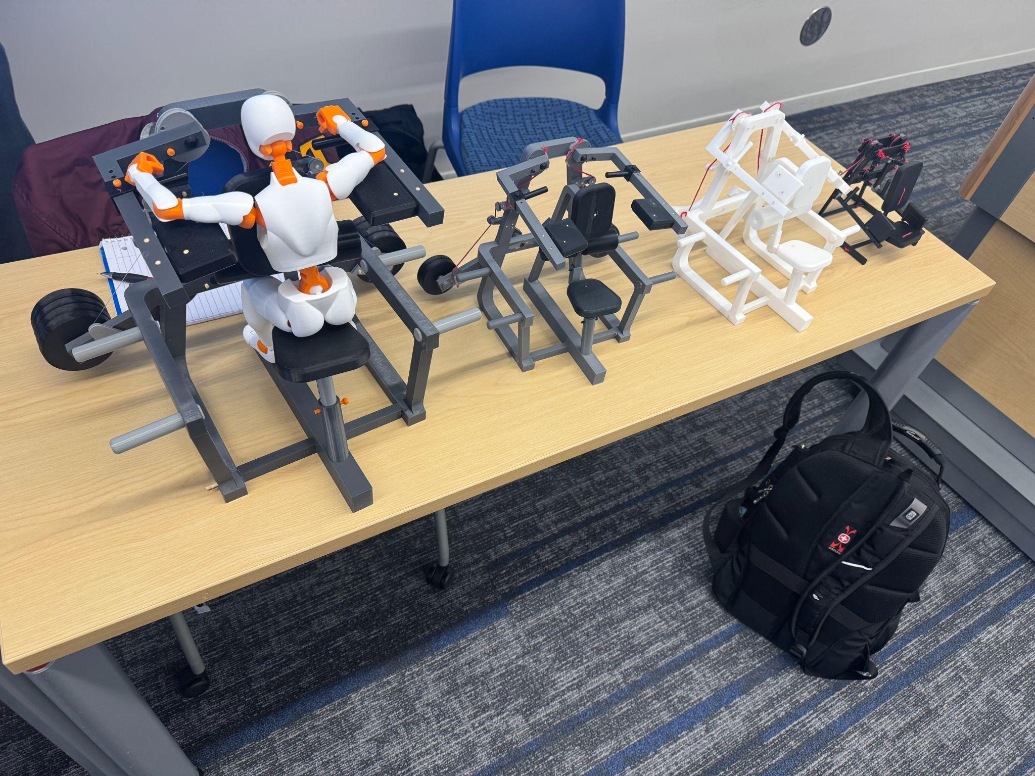 Four 3D-printed prototype generations lined up showing the design evolution